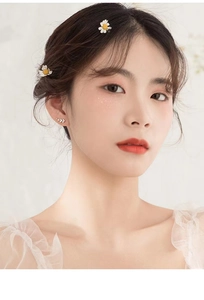 Close-up of minimalist S925 sterling silver branch stud earrings on a model ear