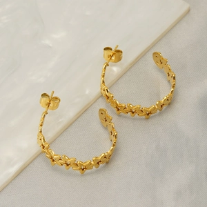 Gold-plated stainless steel star pattern C-shaped hoop earrings on neutral textile