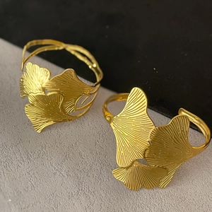 Minimalist gold ginkgo leaf open cuff bracelets with intricate vein texture detail