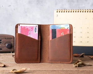 Detail view of a vintage brown leather wallet with multiple card slots and rustic decor