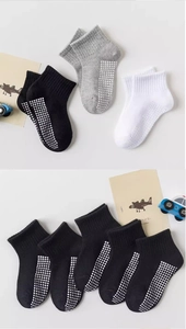 Detailed view of anti-slip silicone dots on cotton mesh socks for babies and toddlers