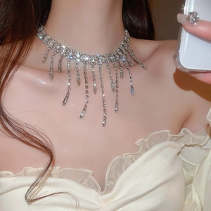 Close-up of sparkling silver tassel choker with rhinestones on an elegant model
