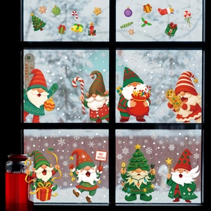 Christmas gnome window clings with snowflakes and trees on a glass window frame