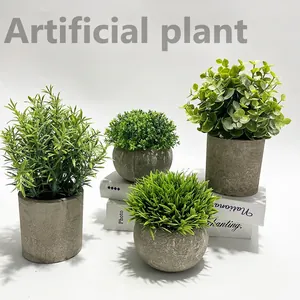 Set of four artificial eucalyptus plants in gray minimalist cement pots on white background