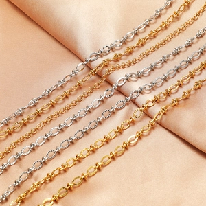 Polished 4.5mm stainless steel lip link chains in gold and silver on pink silk background