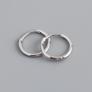 Macro detail of polished s925 sterling silver hoop earrings with secure clasp closure