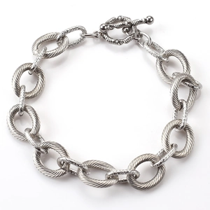 Detailed view of silver chunky link bracelet with a classic toggle clasp on white background