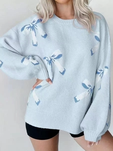Close-up of coconut tree pattern and knit texture on this casual blue crewneck sweater