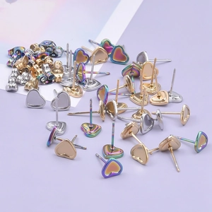 Detailed view of heart-shaped stainless steel stud earrings in gold, silver, and rainbow