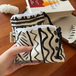 Detail of bohemian canvas coin purse with black and white geometric patterns and zipper