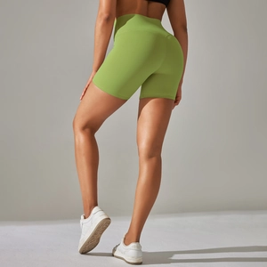 Close-up of fruit green high-waisted yoga shorts with seamless contouring and peach lift