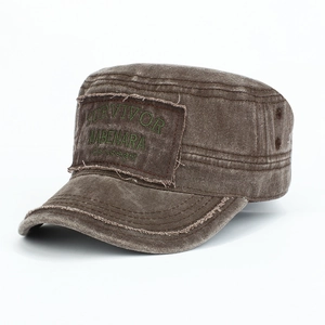 Close-up of vintage brown cadet cap with survivor embroidery and raw edges on washed cotton