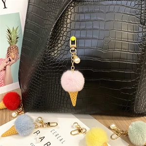 Detailed view of cute faux fur ice cream cone keychain featuring pearl and golden clip.