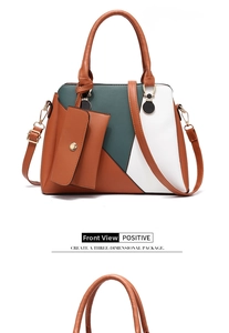 Front detail of color-block tote bag with a small matching purse and golden hardware