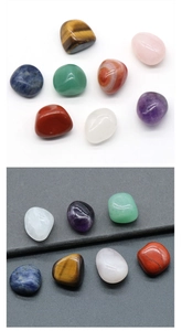 Detailed view of eight irregular tumbled natural chakra crystals on white and dark backgrounds