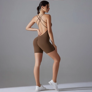 Detail of cross-back straps and lifting fit on a brown shaping yoga romper bodysuit