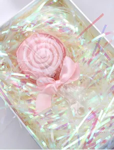 Lollipop soap in a white gift box with iridescent shredded paper and a pink ribbon