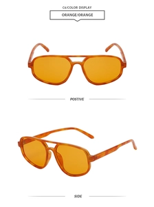 Detail view of stylish orange sunglasses with tortoiseshell frames and translucent lenses