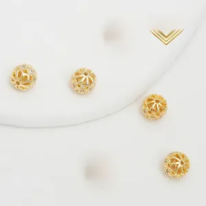 Close-up of 18K gold plated hollow floral beads with micro paved cubic zirconia
