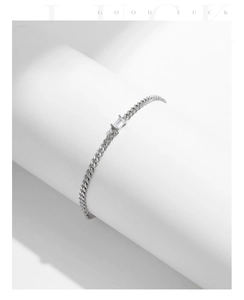 Close-up of s925 silver Cuban chain bracelet with emerald-cut cubic zirconia