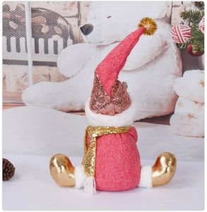 Detail of plush Christmas doll featuring sparkling champagne sequins and pink fabric textures