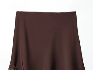Detail of chocolate brown satin skirt featuring delicate floral lace trim along the hem