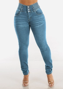Detail of high waist blue stretch jeans with three-button closure and elastic waist design