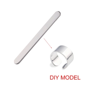 Polished 5mm stainless steel strip and finished DIY open ring on white background