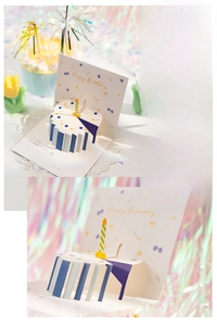 Detail of 3D pop-up birthday cake card with happy birthday text on laser background