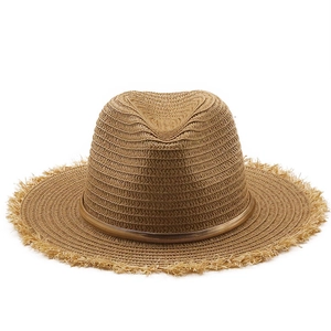 Classic straw sun hat with frayed edges and golden ribbon for summer travel protection