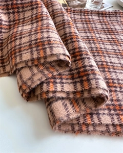 Close-up of soft plaid cashmere-like scarf with fringe details and vintage patterns