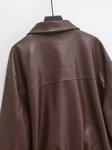 Detail view of the brown faux leather jacket back with reinforced seam stitching