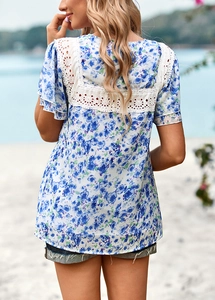 Detail of blue floral print top with white lace patchwork back against beach scenery