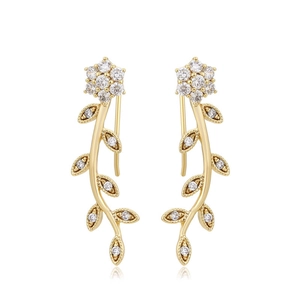 Detailed macro view of 14K gold floral ear crawlers with sparkling zircon stones
