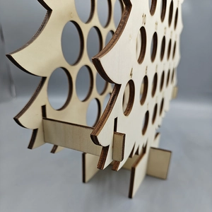 Close-up of wooden Christmas tree wine rack with numbered countdown slots and joints
