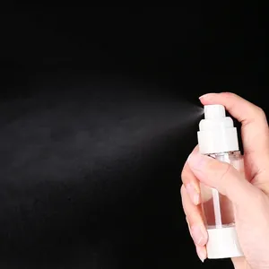Portable clear vacuum spray bottle showing fine mist atomization on black background