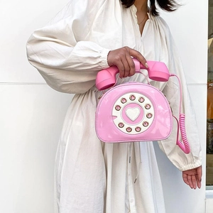Creative pink telephone-shaped crossbody bag with vintage dial and heart detail