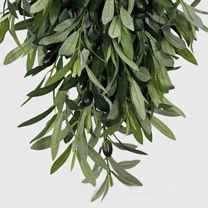 Close-up of artificial olive wreath with detailed green leaves and black olive fruits