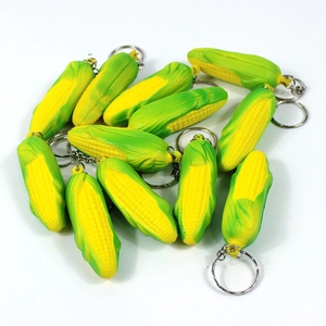 Detailed view of multiple realistic mini corn keychains with yellow kernels and green husks