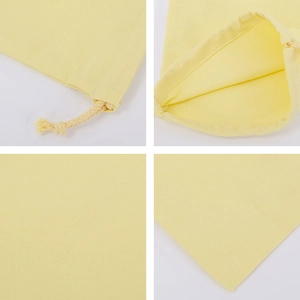 Detail view of yellow canvas drawstring bag showing stitching, texture and rope closure