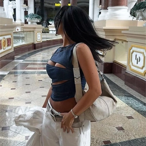 Detail of dark blue cutout denim crop top with sexy hollow design and street style look