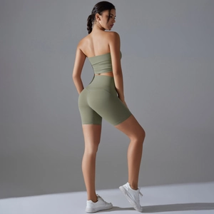 Detail view of high-waist fitness shorts and bandeau top in olive green yoga set