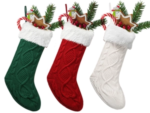 Three large knitted Christmas stockings with plush trim filled with festive decorations