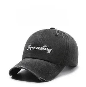 Detailed view of the Ascending letter embroidery and distressed rips on the charcoal cap