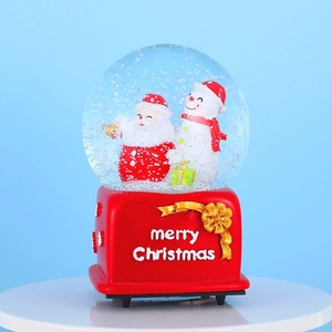 Christmas musical snow globe with Santa Claus and Snowman on a red merry Christmas base