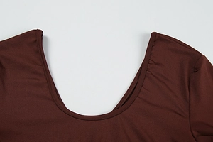 Detail of dark brown U-neckline stitching and ribbed texture on slim fit dress