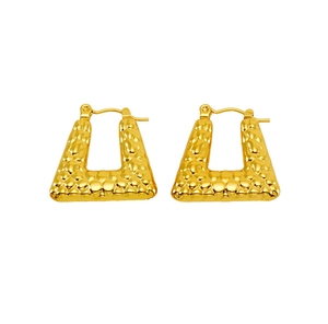 Detail of gold-tone geometric U-shaped earrings with unique hammered texture finish