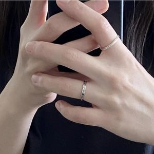 Close-up of minimalist 925 sterling silver rings with smooth and textured vintage bands