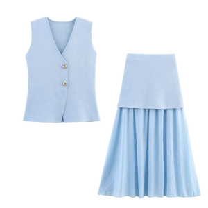 Detail of light blue V-neck vest with gold buttons and pleated skirt texture