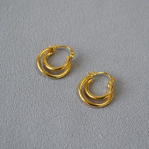 Elegant gold plated double hoop twisted earrings with a minimalist polished brass finish